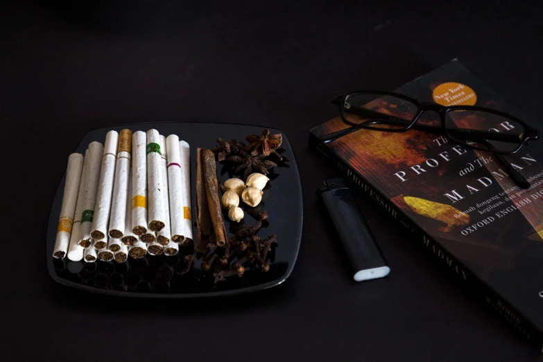 many cigarettes and a cigarette lighter on a black table