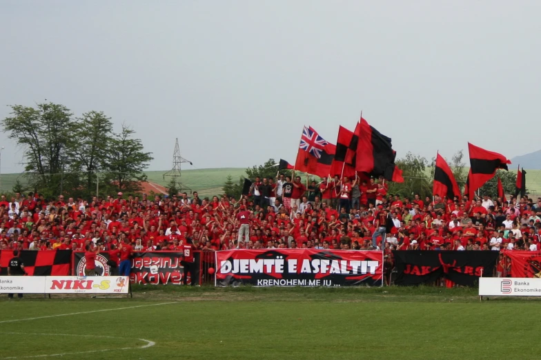 fans at a soccer match with red flags