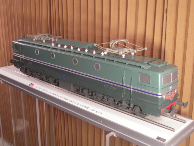 a model train on display near brown walls