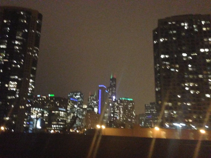 some buildings in the night with a cloudy sky