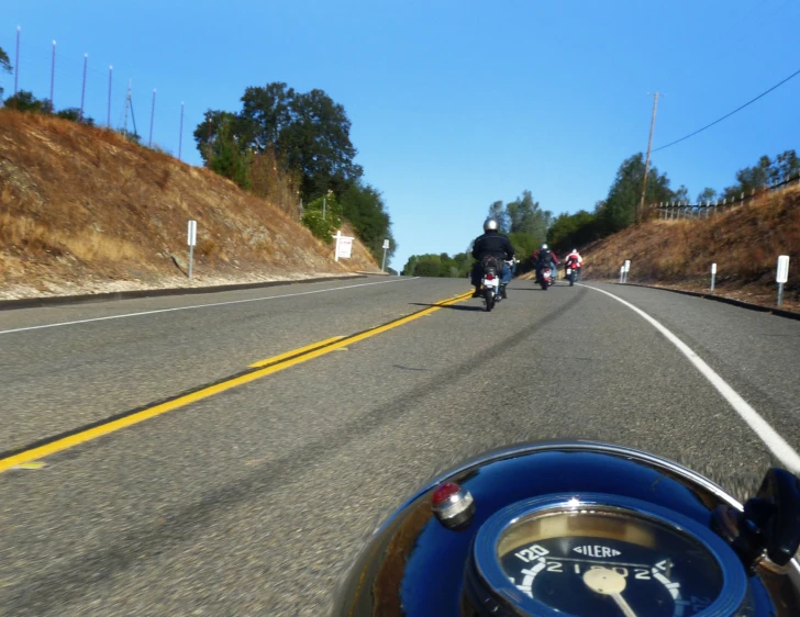 several motorcyclists are on a road in the daytime