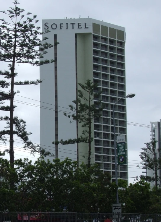 the el is in the foreground of a fenced in area