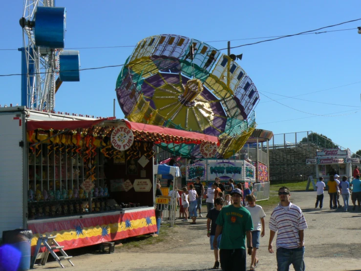 several people are walking in line at a fair