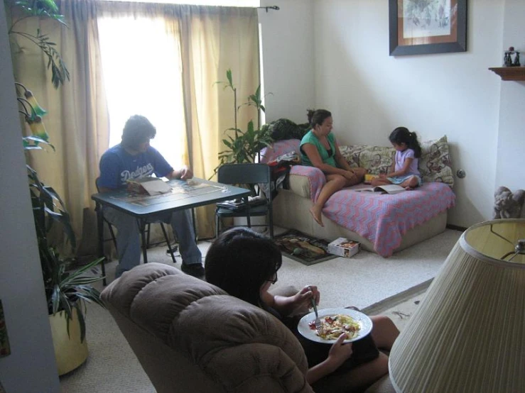 people are eating breakfast on the floor by the window