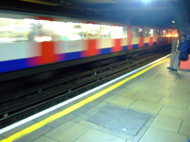 two men waiting for a train at night