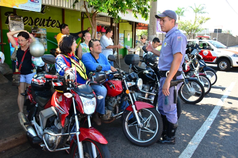 a number of people near many motorcycles