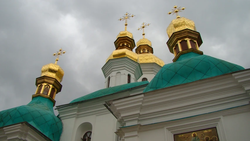 the top of two buildings with crosses on them