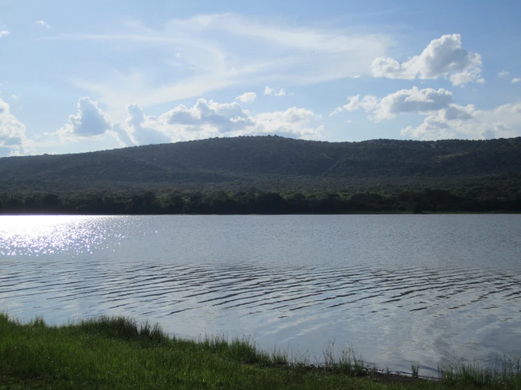 the sun is shining on the still water