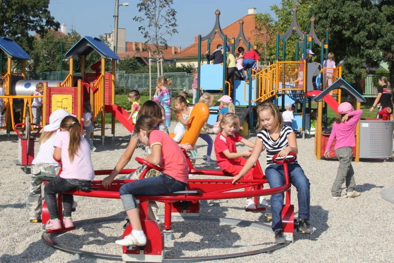 s sitting on a children playground playing