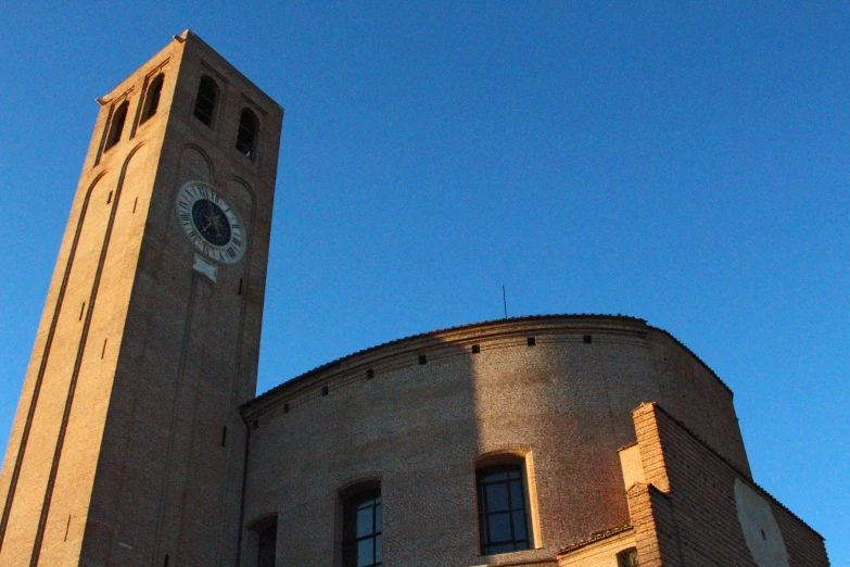 a clock tower is next to a large stone building