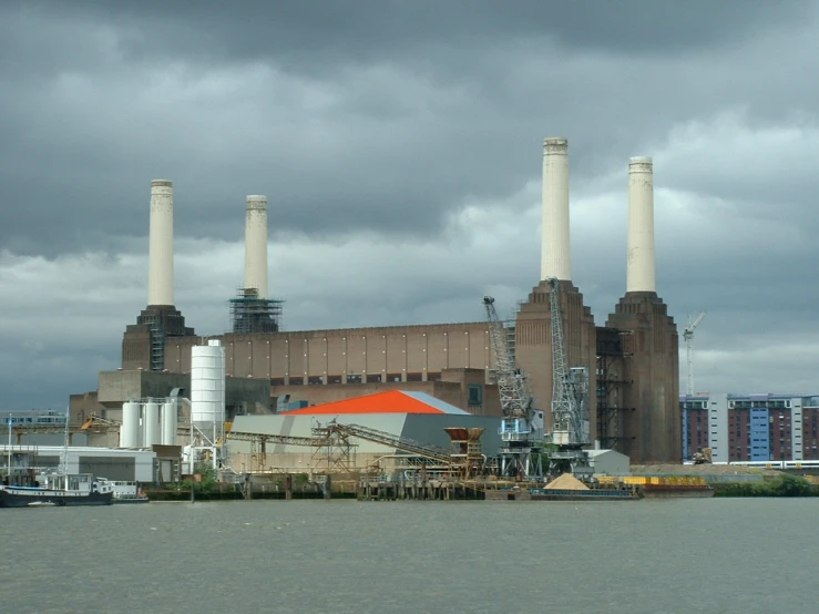 an industrial factory near a river and boat