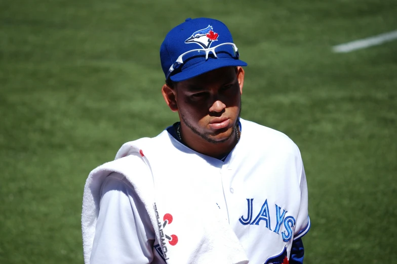 the baseball player in uniform is waiting for his turn