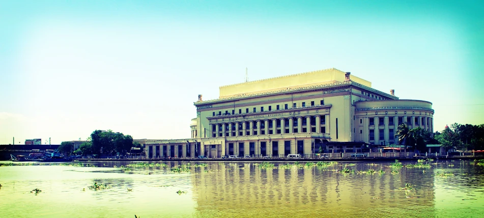 a building is surrounded by water and a sky background