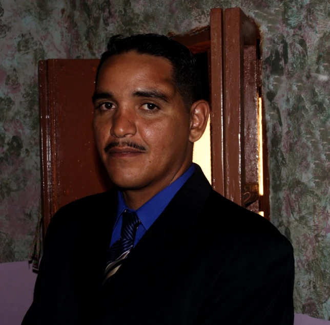 a man in a suit posing for the camera