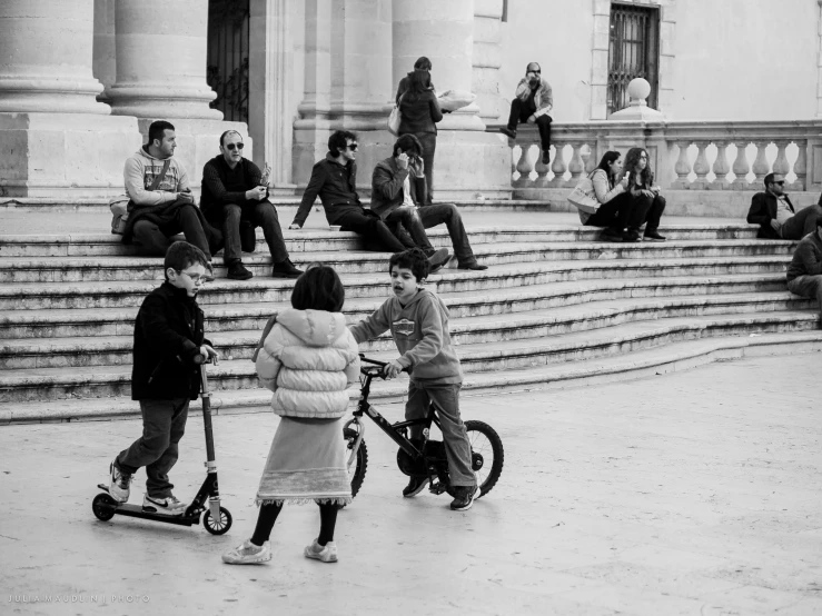 some s are playing on a skateboard outside