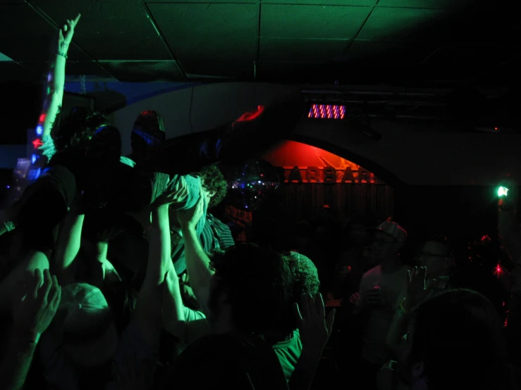 a group of people dancing together at a party