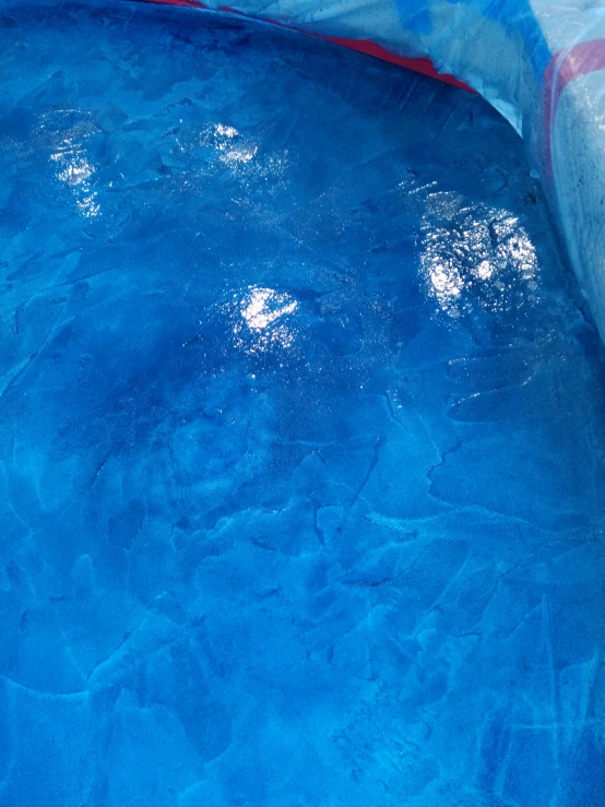 a blue and white pool with waves in it