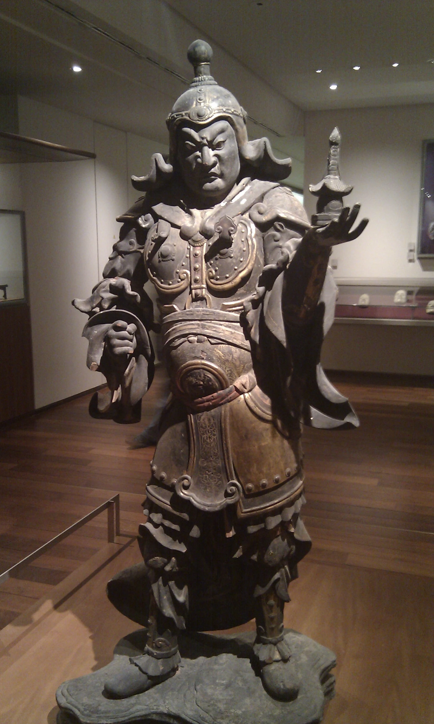 a statue on display in the center of a museum