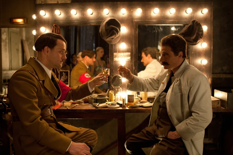 a man and woman in formal wear toasting each others wine glasses