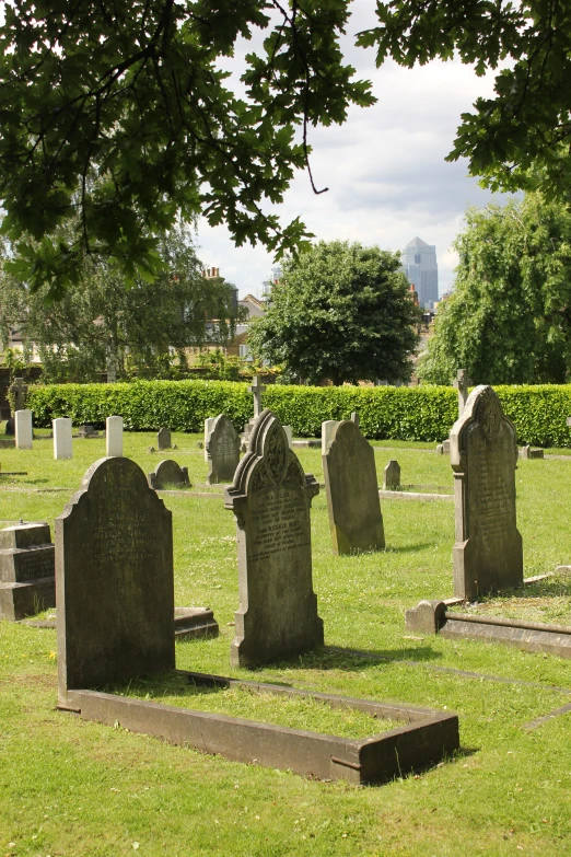 old, creepy graves sit in a cemetery