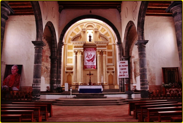 this is the inside of a church with an altar and pews