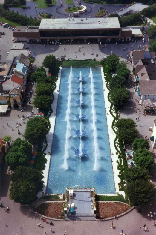 an aerial view of a swimming pool with fountains