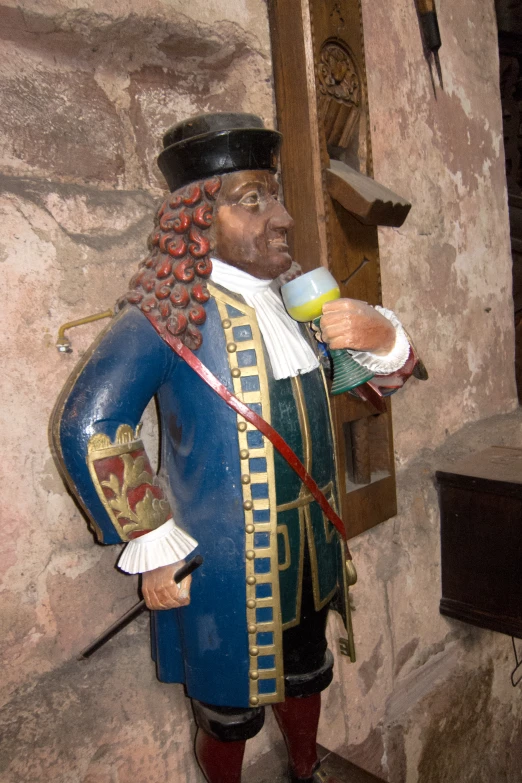 a small statue of a man dressed in medieval clothing
