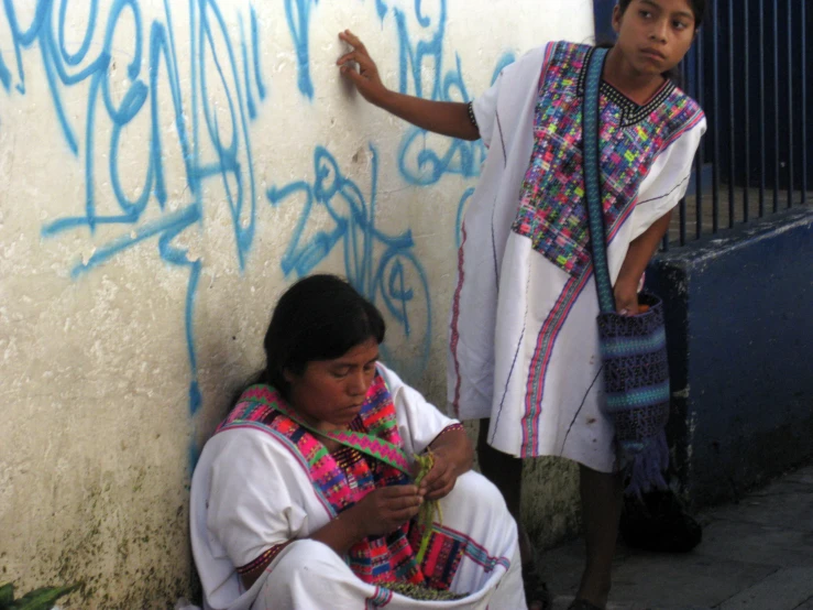 a group of people that are standing by some wall