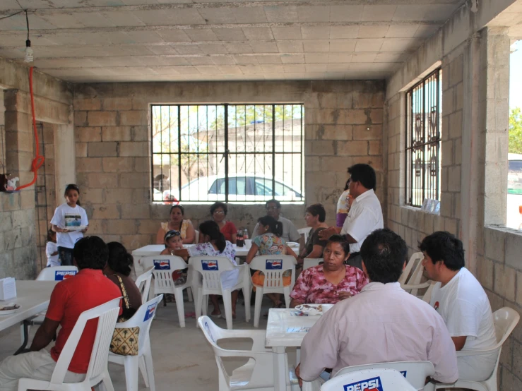 a bunch of people eating at some tables