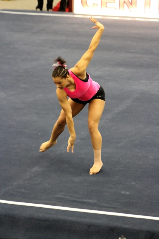 a young female tennis player is swinging at the ball