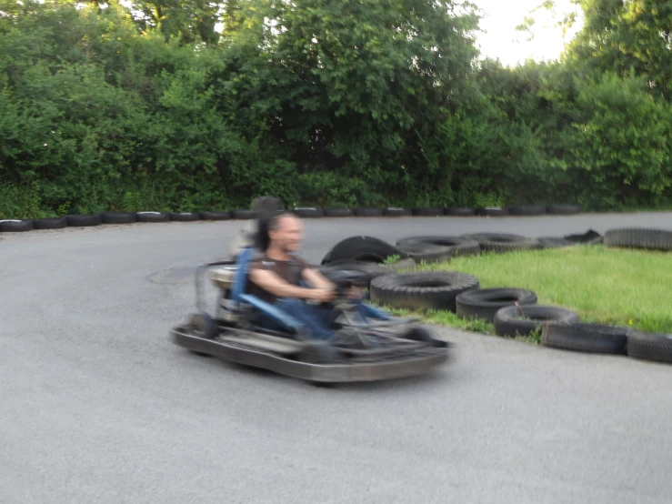 the man rides in an inner tube cart down the road