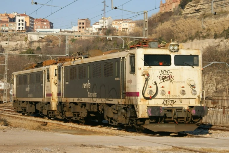 a train has spray painted graffiti on its side