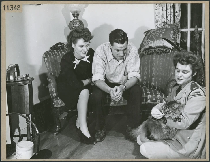 this is a vintage po of some people petting a cat