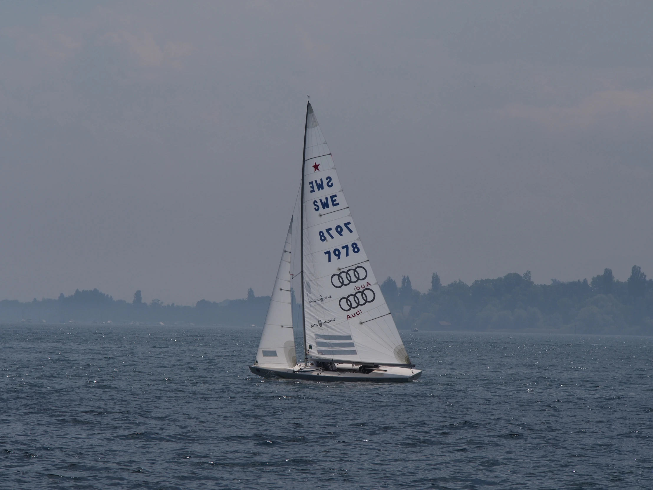 a white sailboat floating on the open ocean