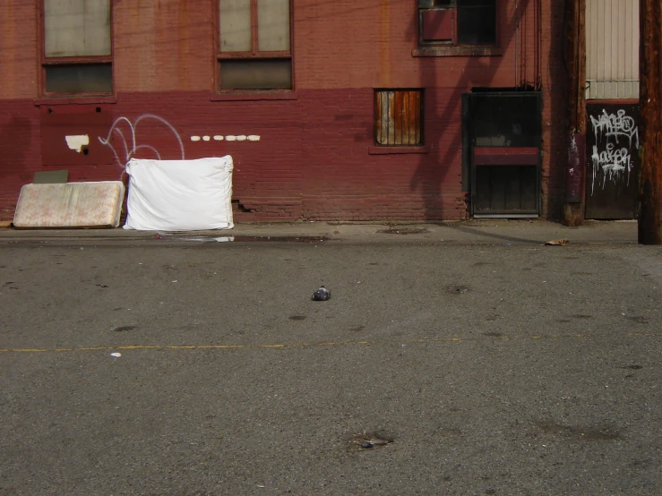 an empty street outside of a building with graffiti