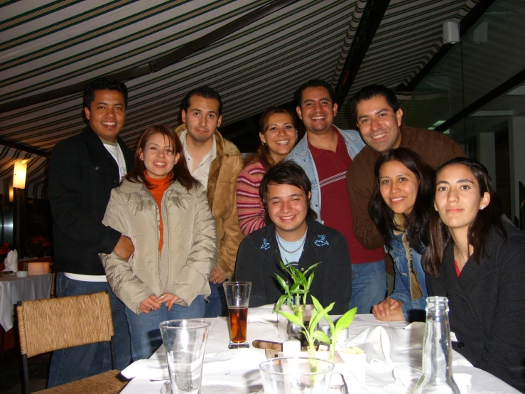 a group of people gather around a dinner table