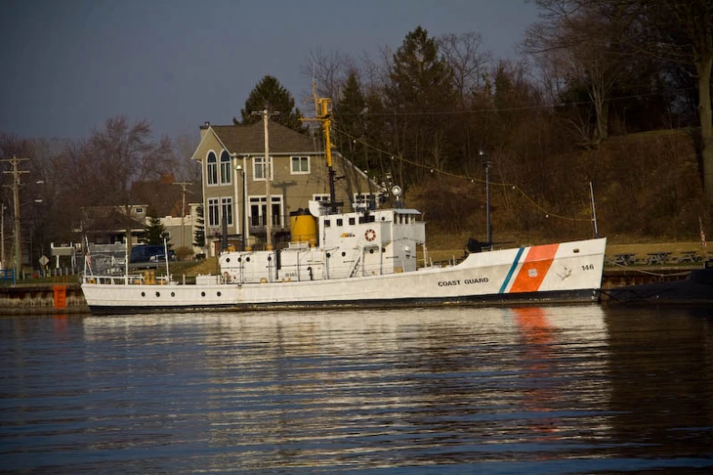 a boat is docked in front of a house