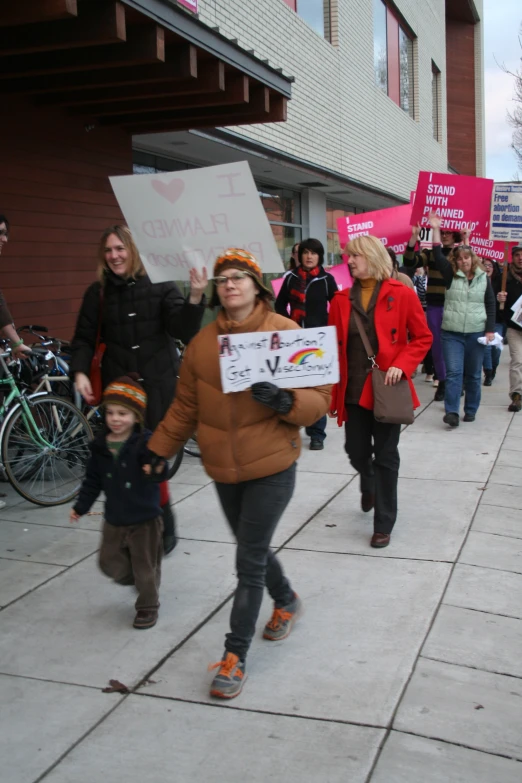 a group of people are marching down the street