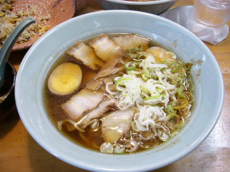 a bowl filled with soup and vegetables on a table