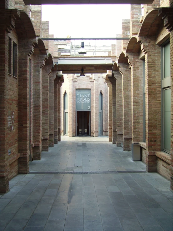 an empty building with a lot of brick pillars in it