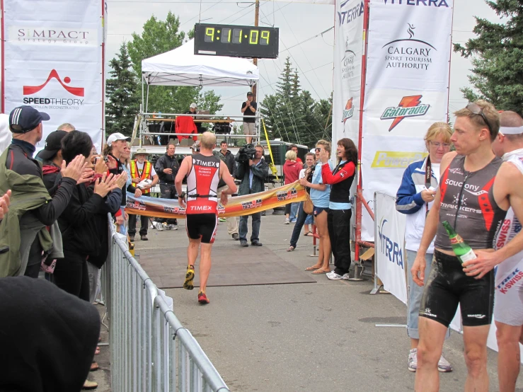 men run the finish line at a marathon