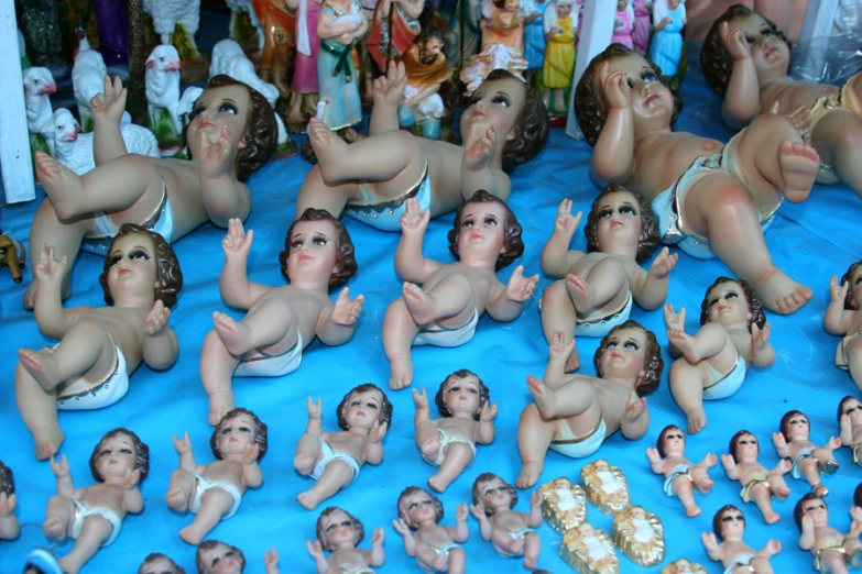a collection of  baby dolls in diapers