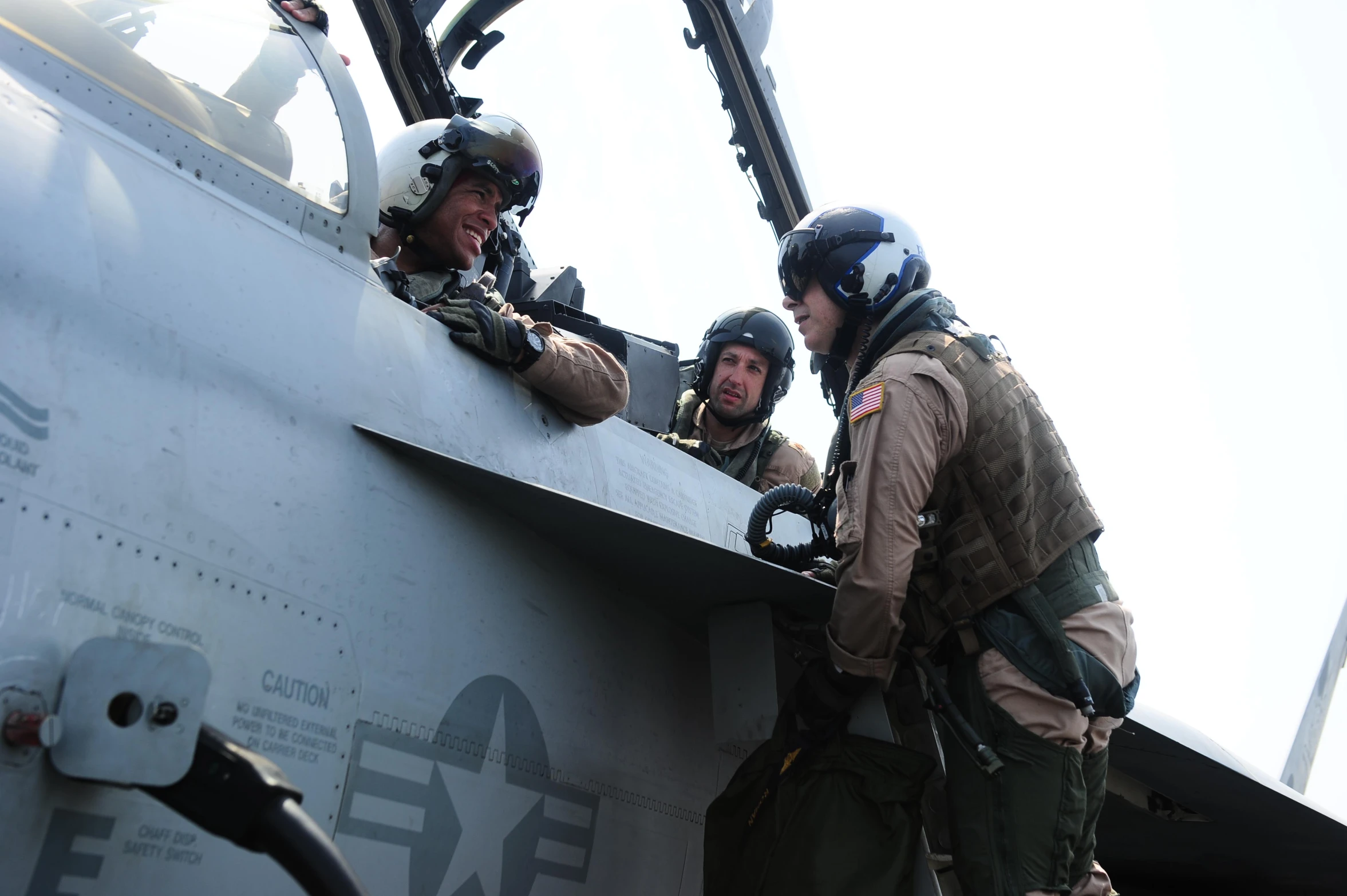 two soldiers talking next to an airplane