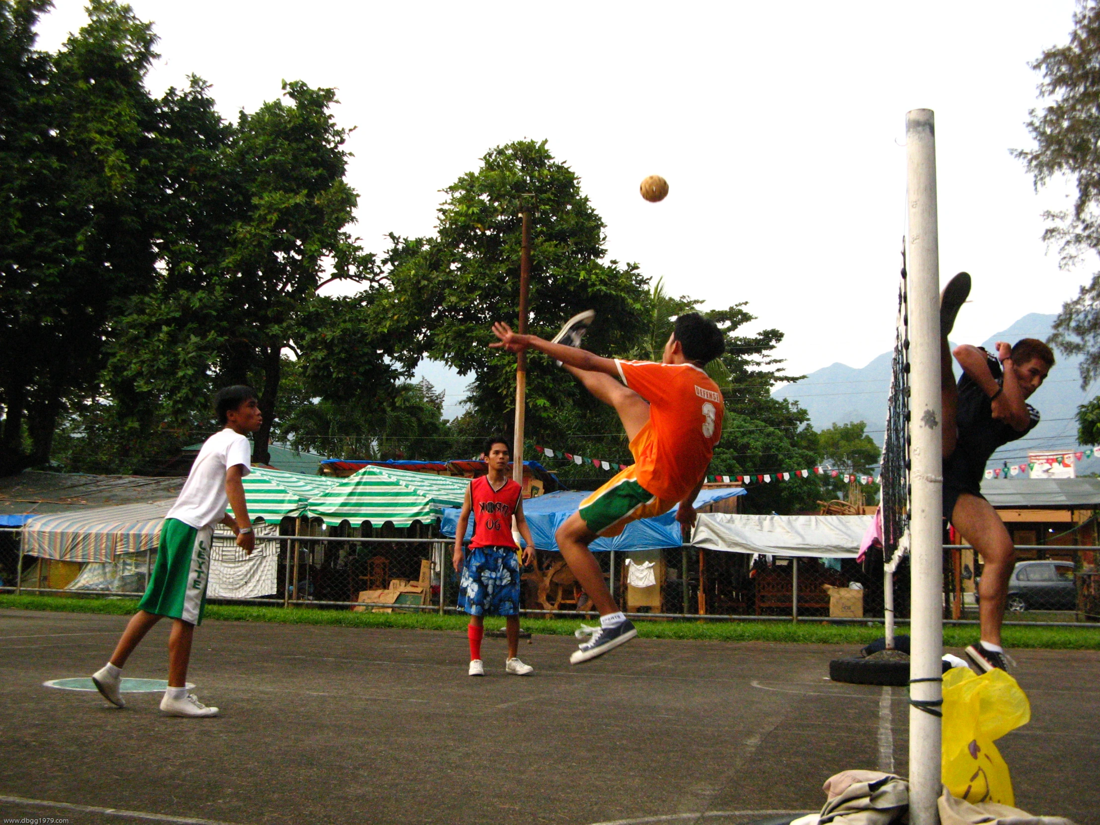 young people are playing beach volleyball outside on the beach