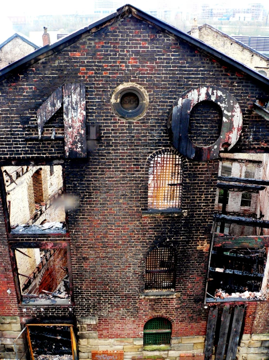 an old, dilapidated building in front of an overpass