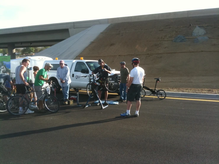 group of men standing around with several bicycles