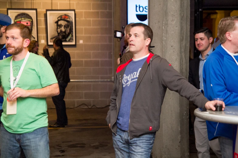 two men standing with wii remotes in their hands