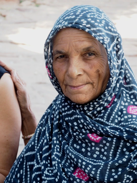 a close up of a person with a scarf on