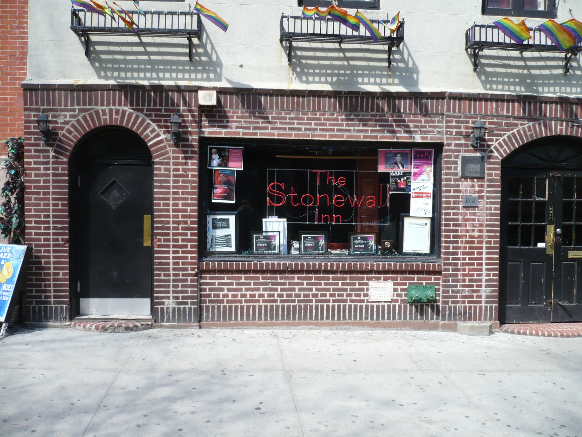 a building with a sign on it sitting next to a sidewalk