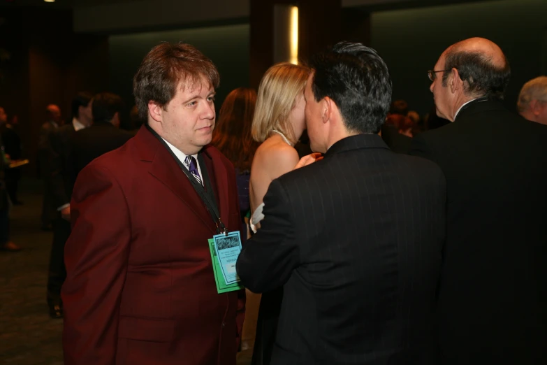 a group of people standing around a room